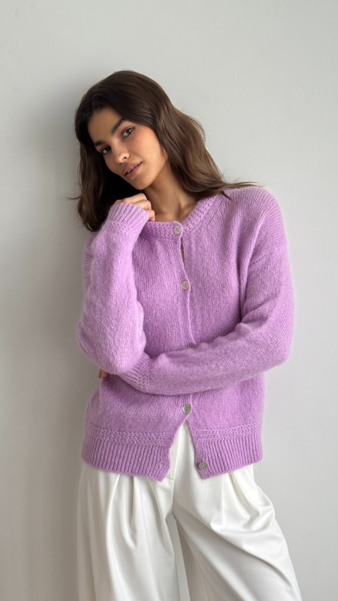 soft lavender cardigan with button details, styled with flowing white wide-leg trousers