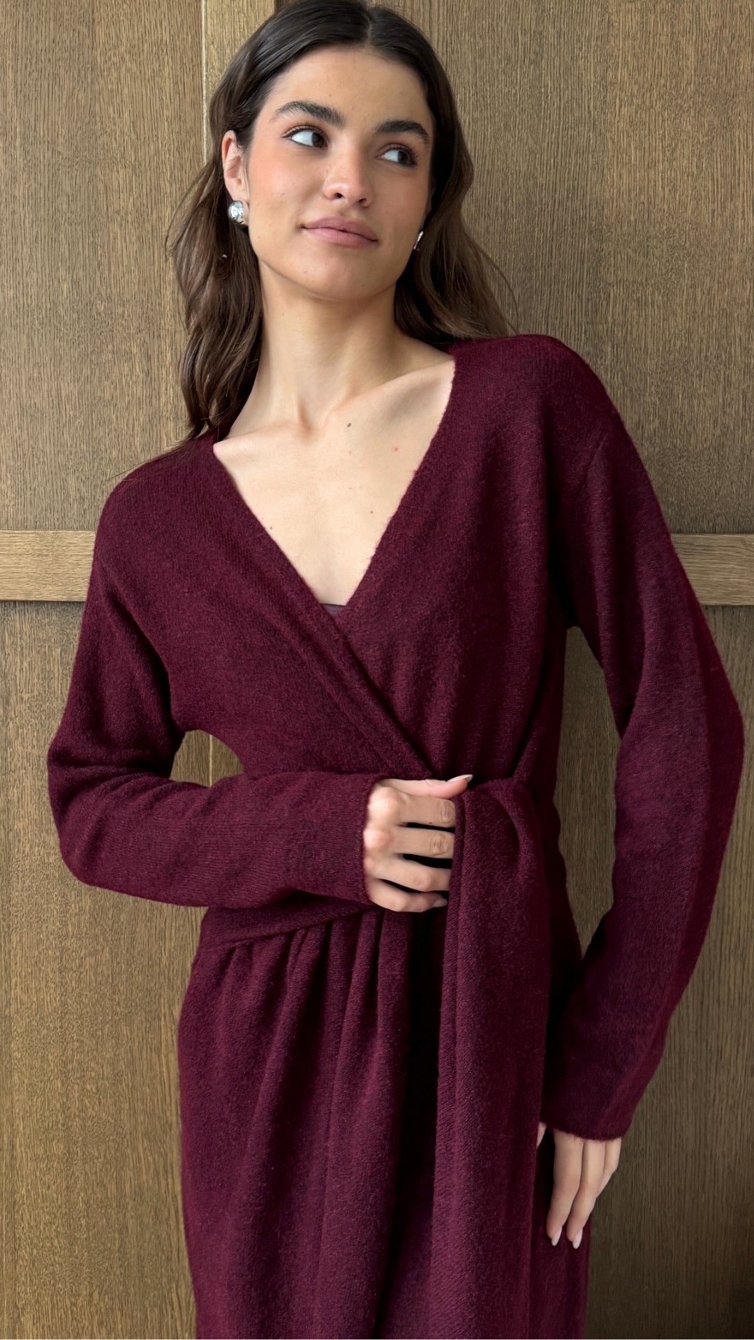burgundy wrap dress featuring a deep V-neckline and tie-waist detail, crafted from soft fabric