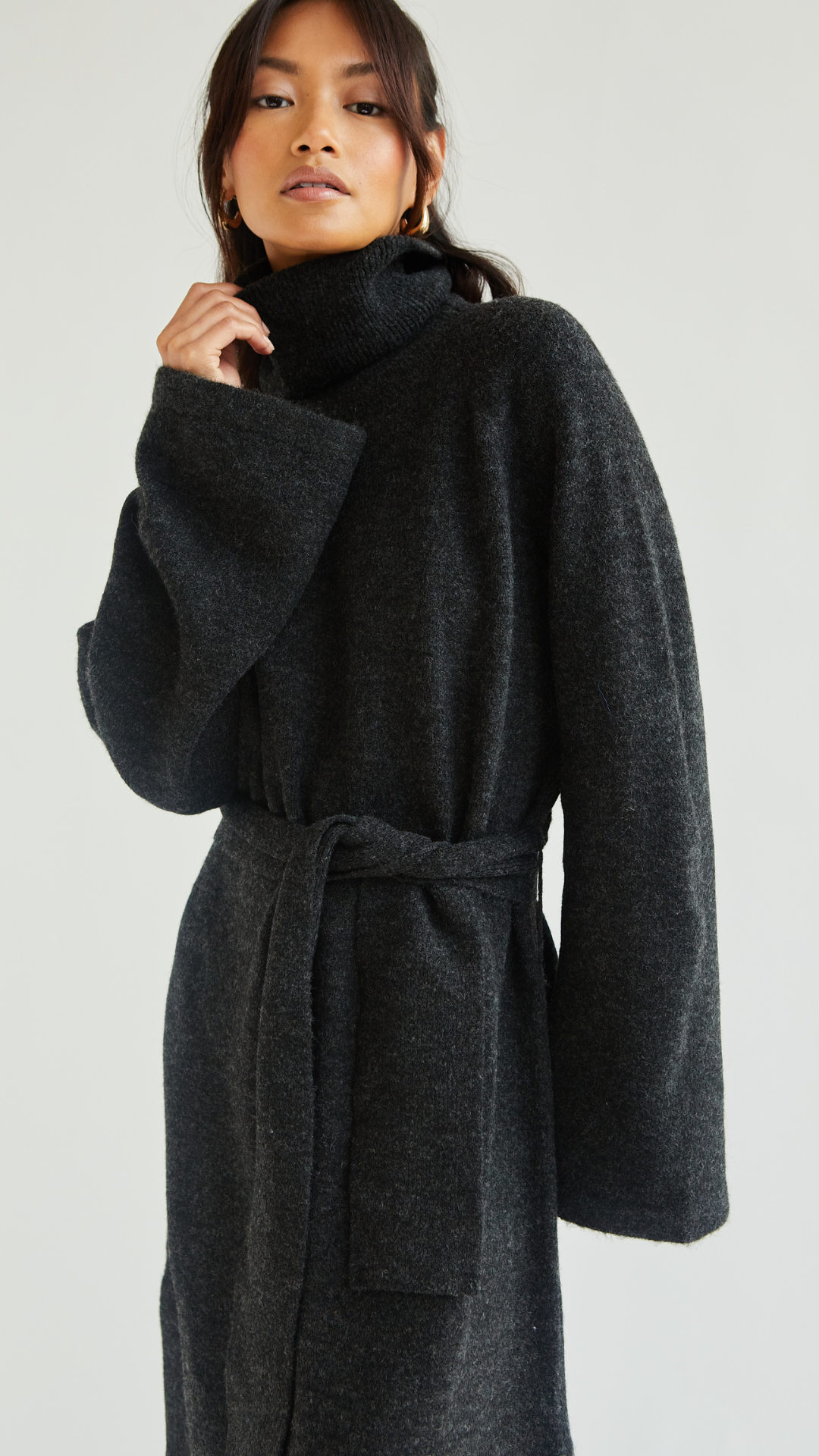 dark charcoal belted turtleneck coat with wide sleeves