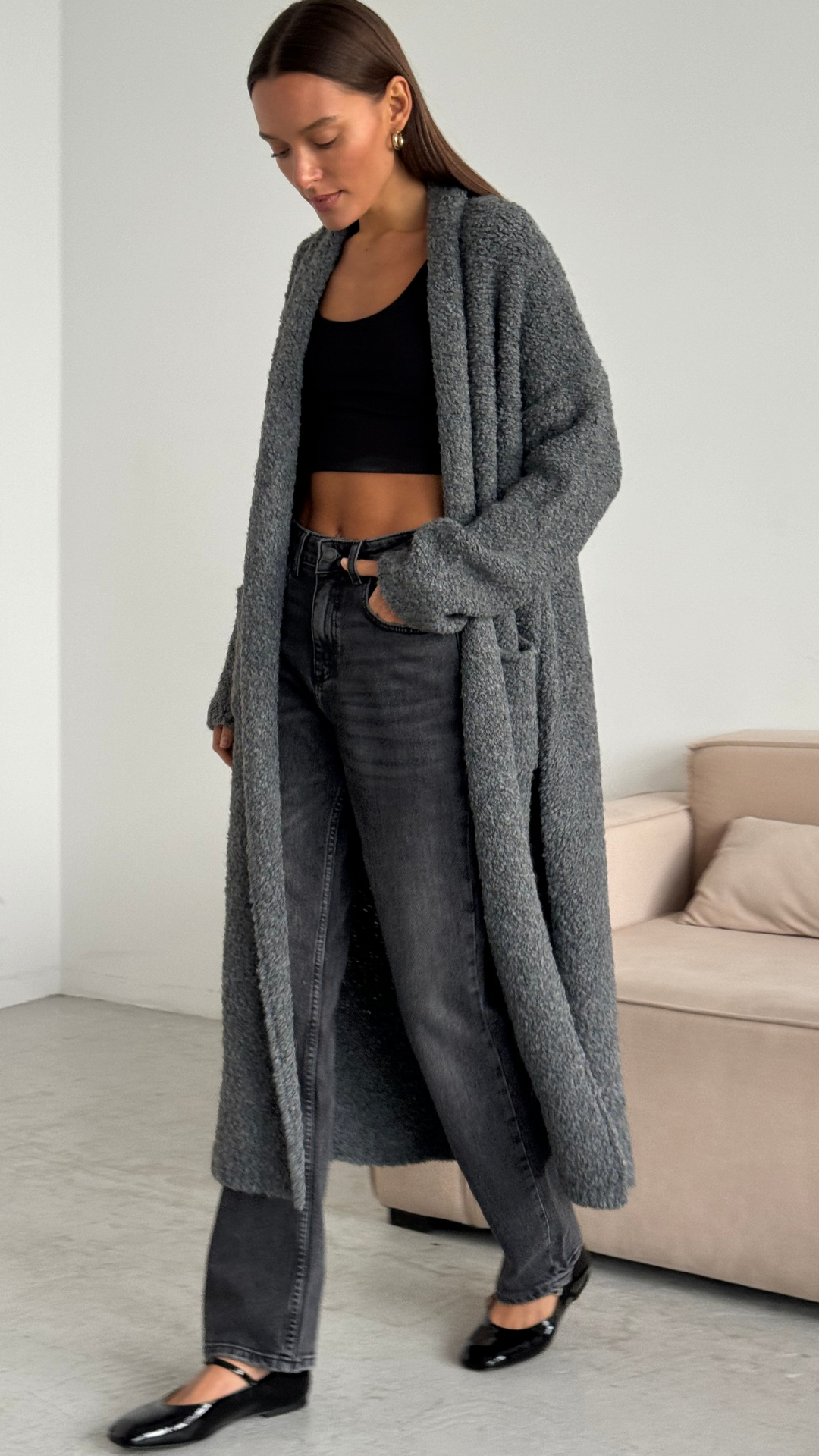 black crop top and grey oversized cardigan with pockets, paired with dark grey jeans