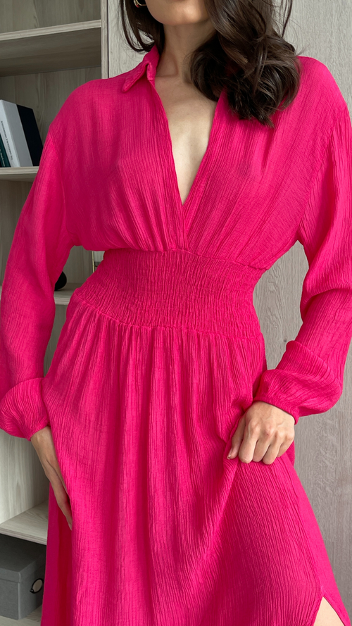 fuchsia pink dress featuring a deep V-neckline, long sleeves, and a smocked waist design
