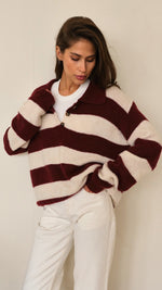 cosy maroon and cream striped knit sweater with a buttoned collar, paired with off-white jeans